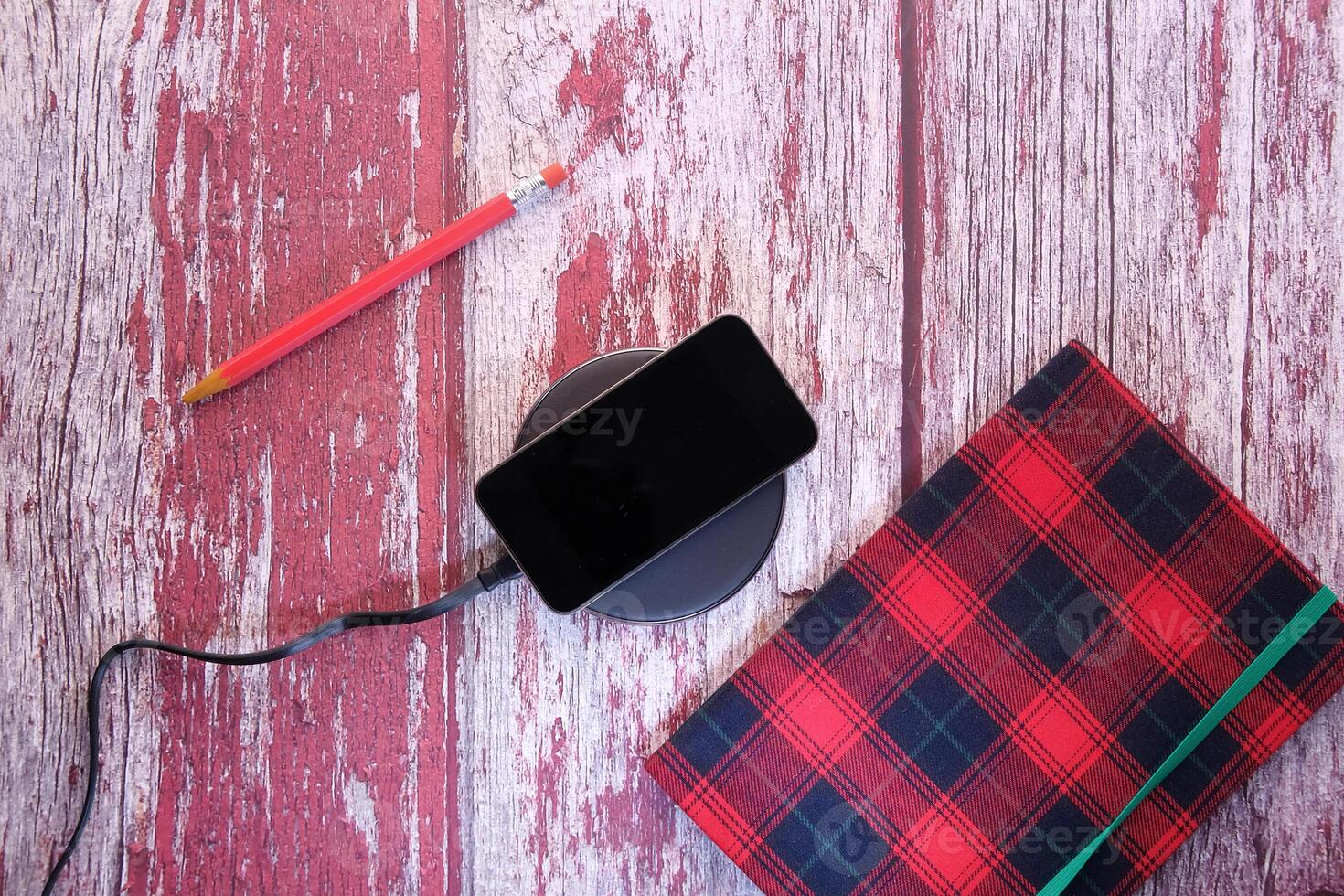 charging Smartphone Using Wireless Charging Pad, top view photo