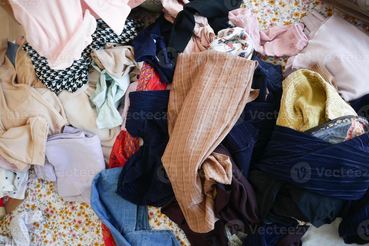 messy bed with cloths in early morning , messy bed after waking up photo
