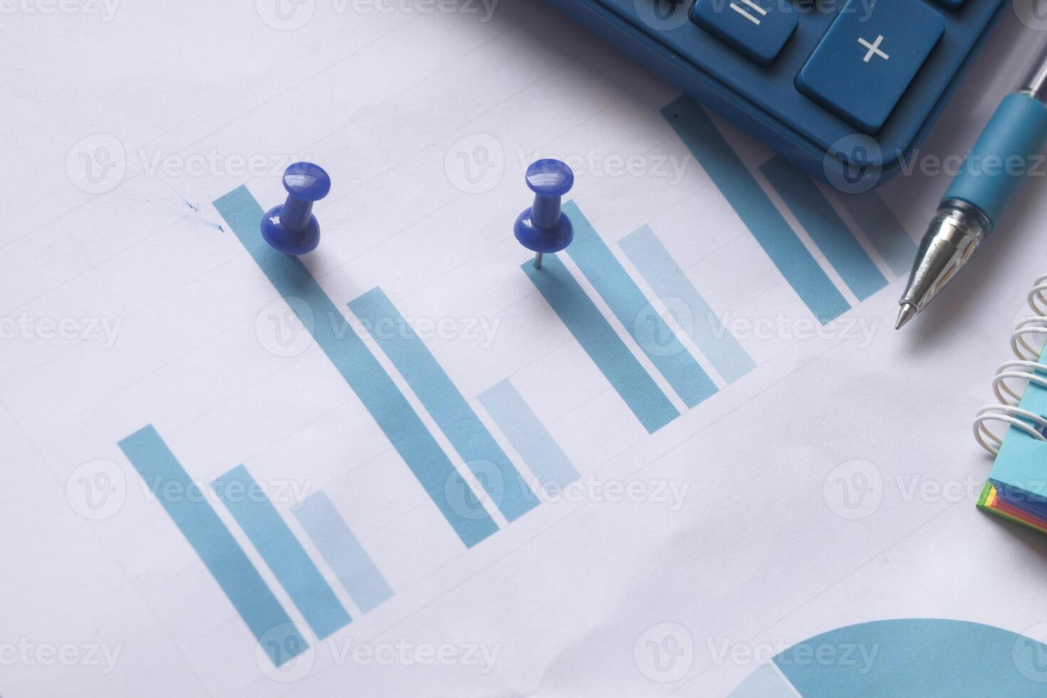 close up of financial charts, calculator and tea on table photo