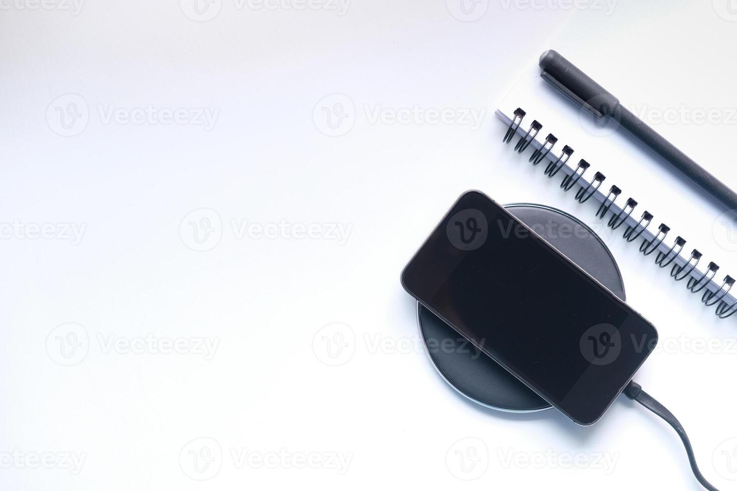 charging Smartphone Using Wireless Charging Pad, photo