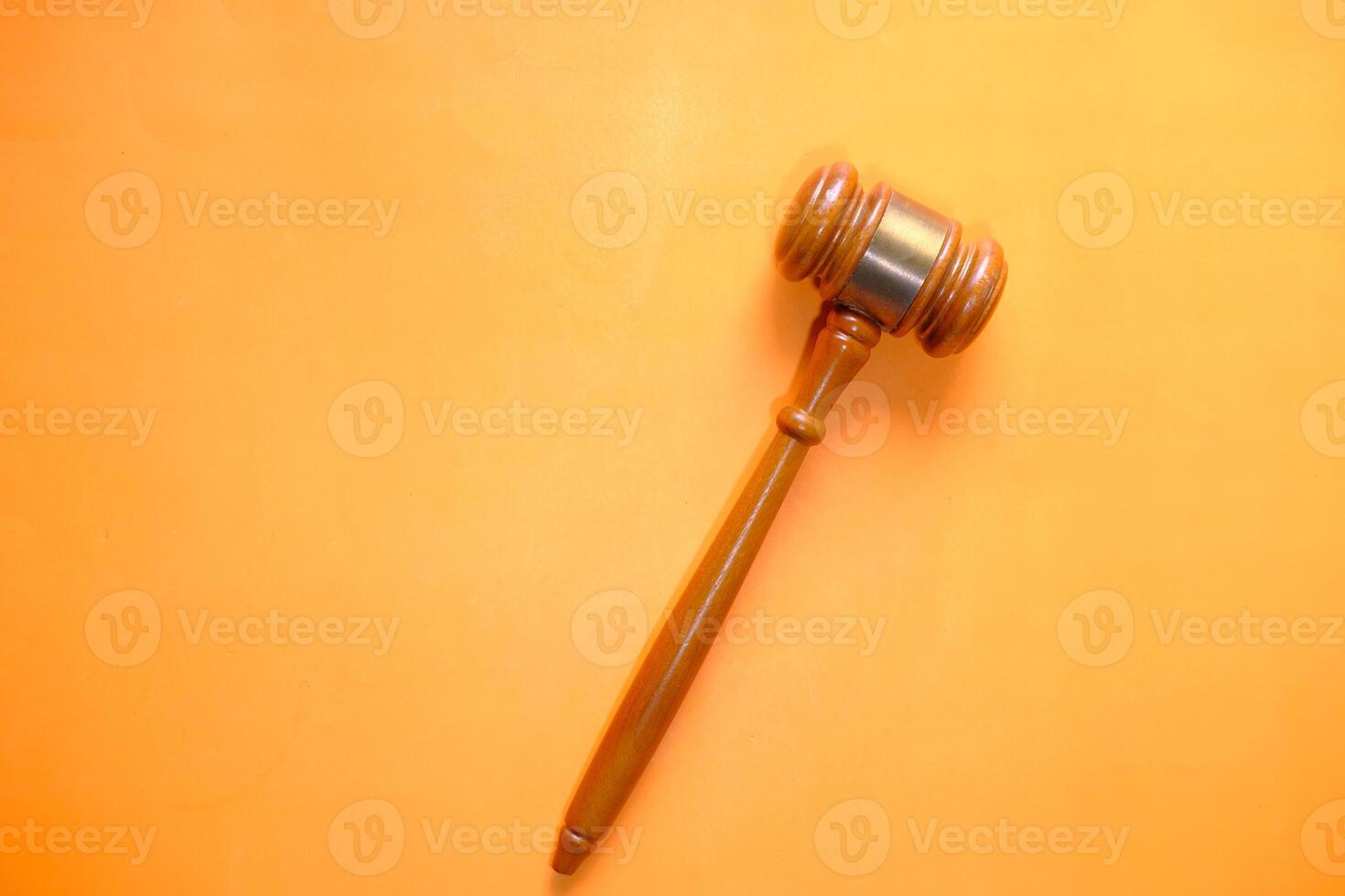 top view of gavel on orange background photo