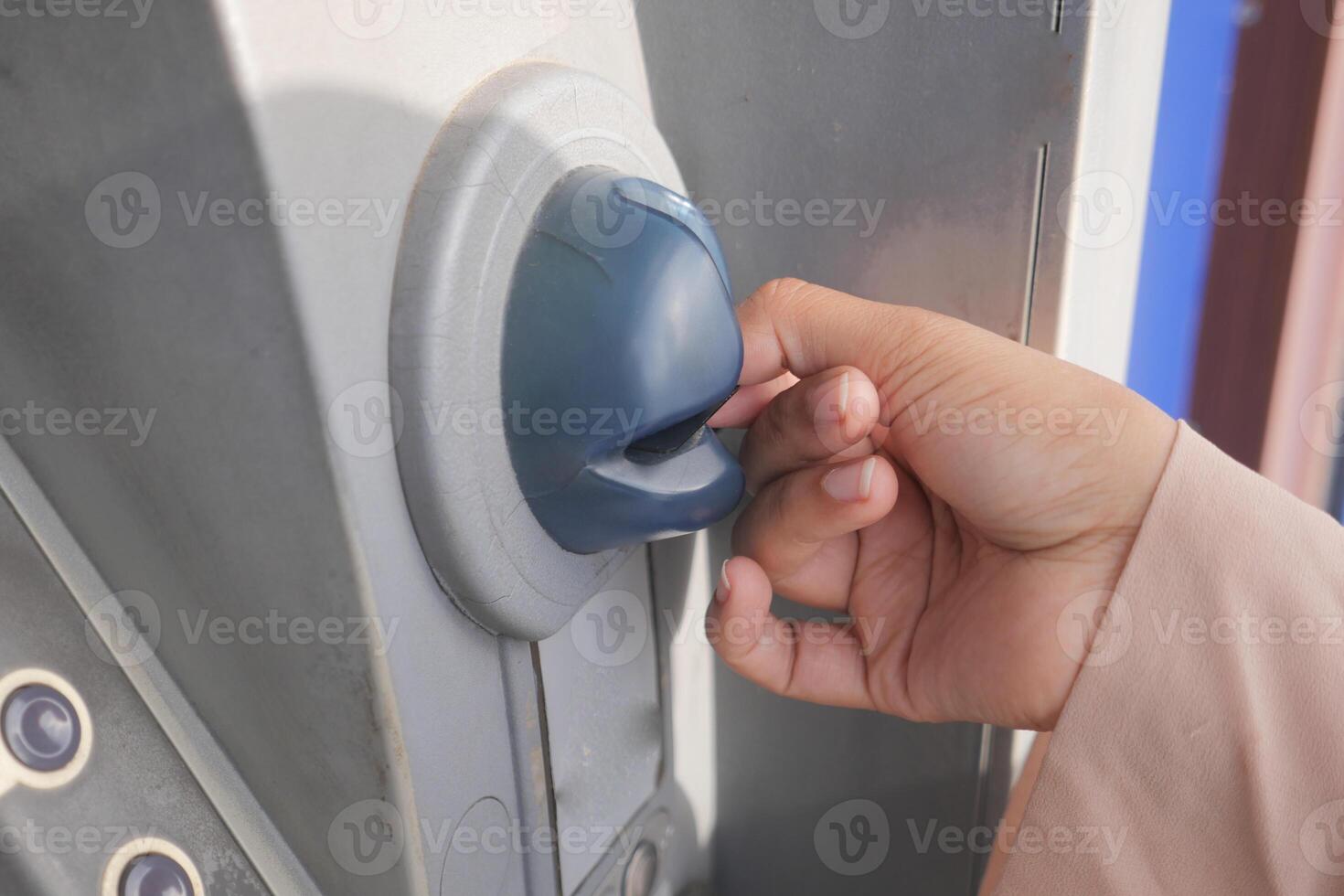 Hand Using Credit Card To Withdrawing Money From Atm Machine. photo