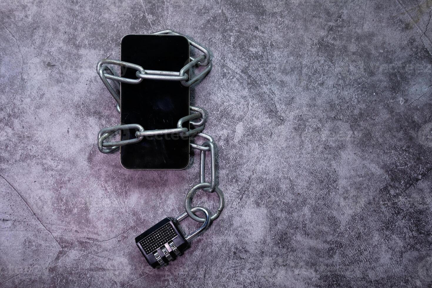 Smart Phone With Padlock And Chain Over White Background. photo