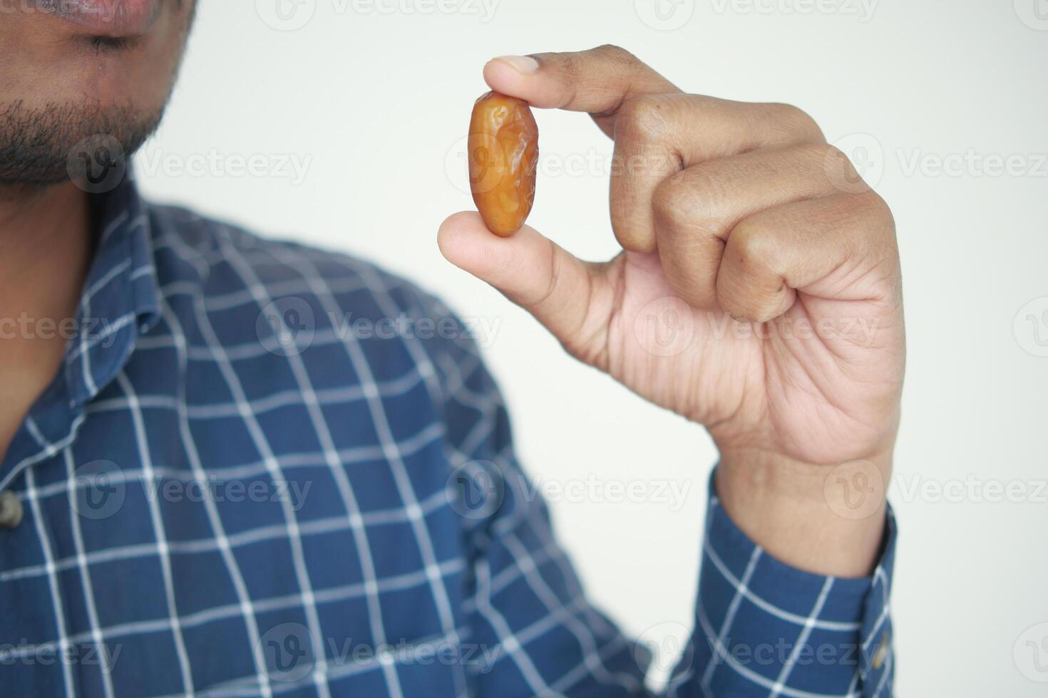 Close up of hand holding a date fruit photo