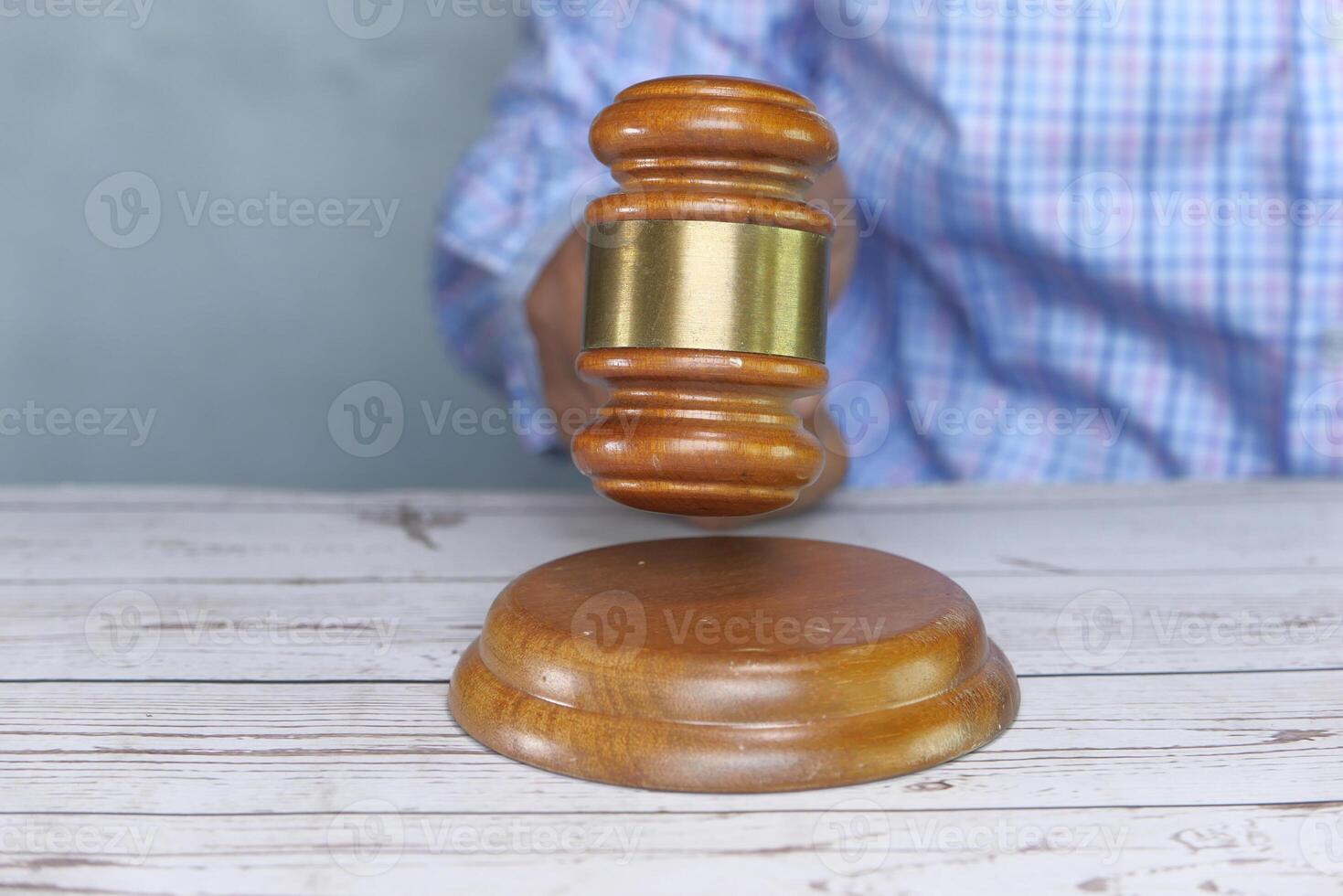 Judge Hand Banging the Gavel on Court Room Table. photo