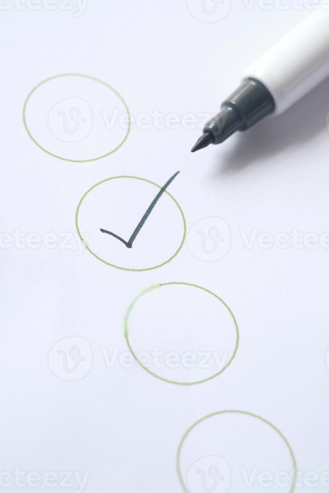 Check list with black pen on paper. photo