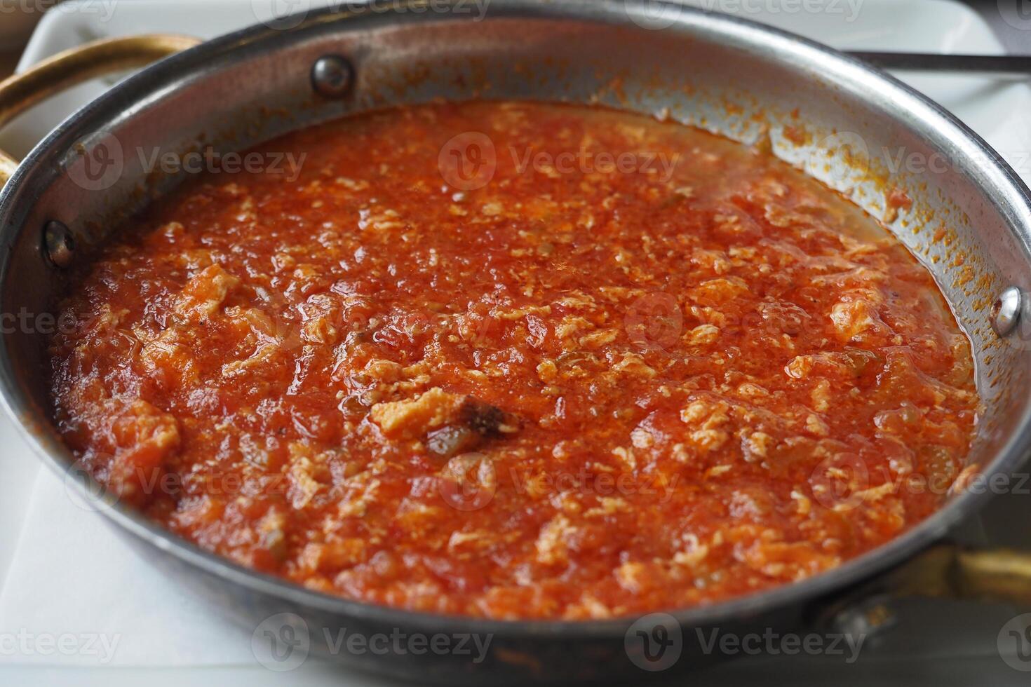 Turkish Menemen omelet in a frying pan. . photo