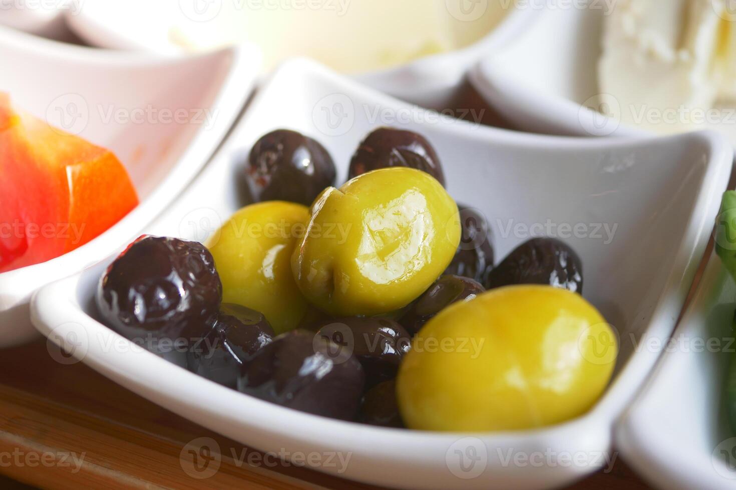 Collection of black and green olives with leaves. photo