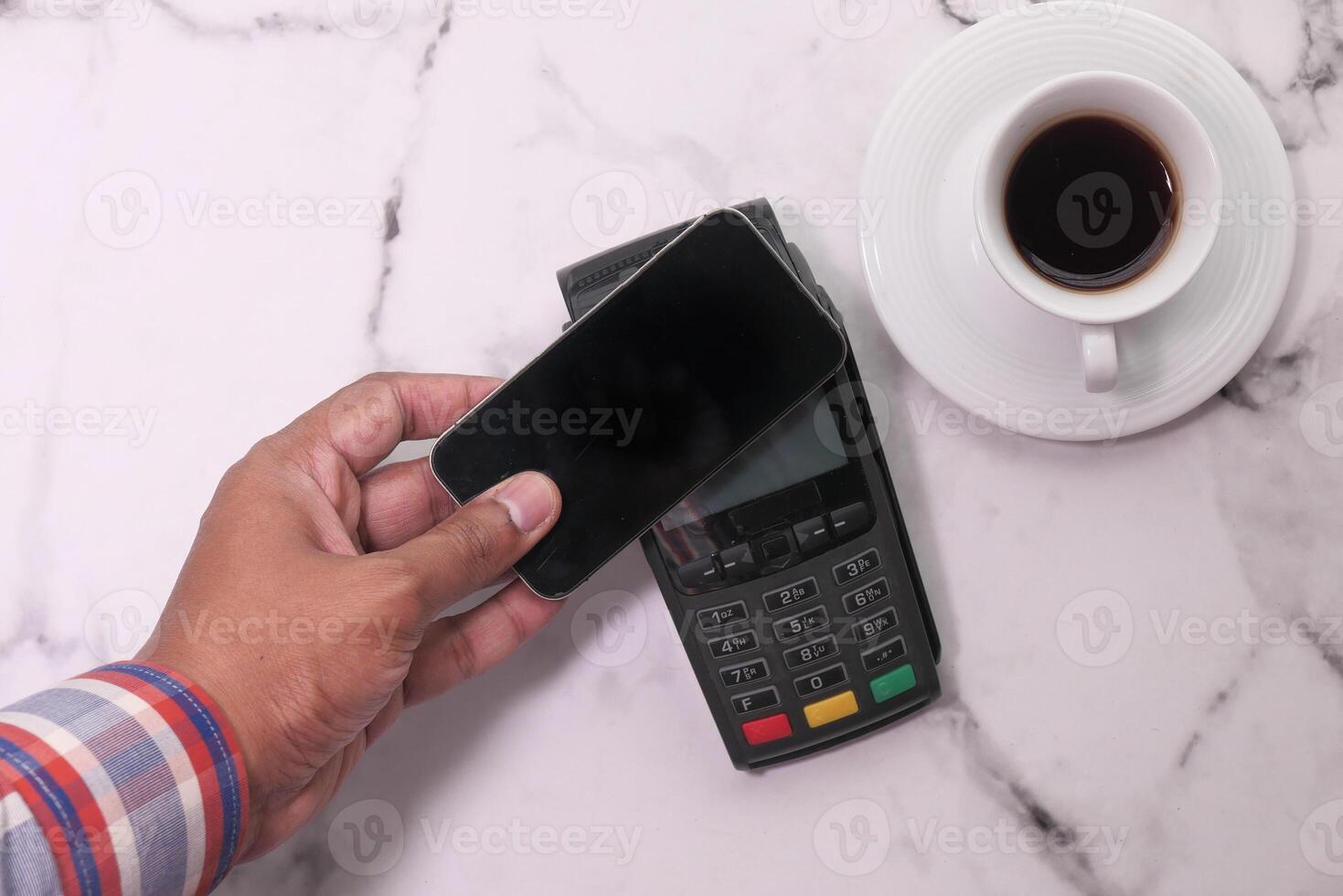 Payment terminal charging from a smart phone , contactless payment. photo