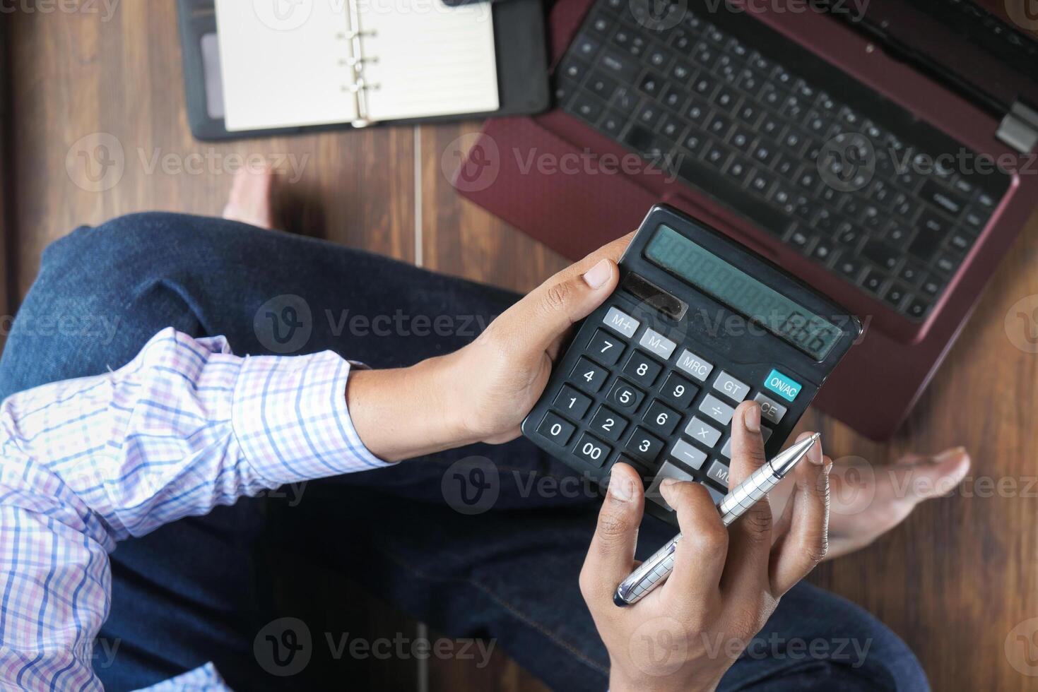 work from home concept, Top view of man using calculator. photo