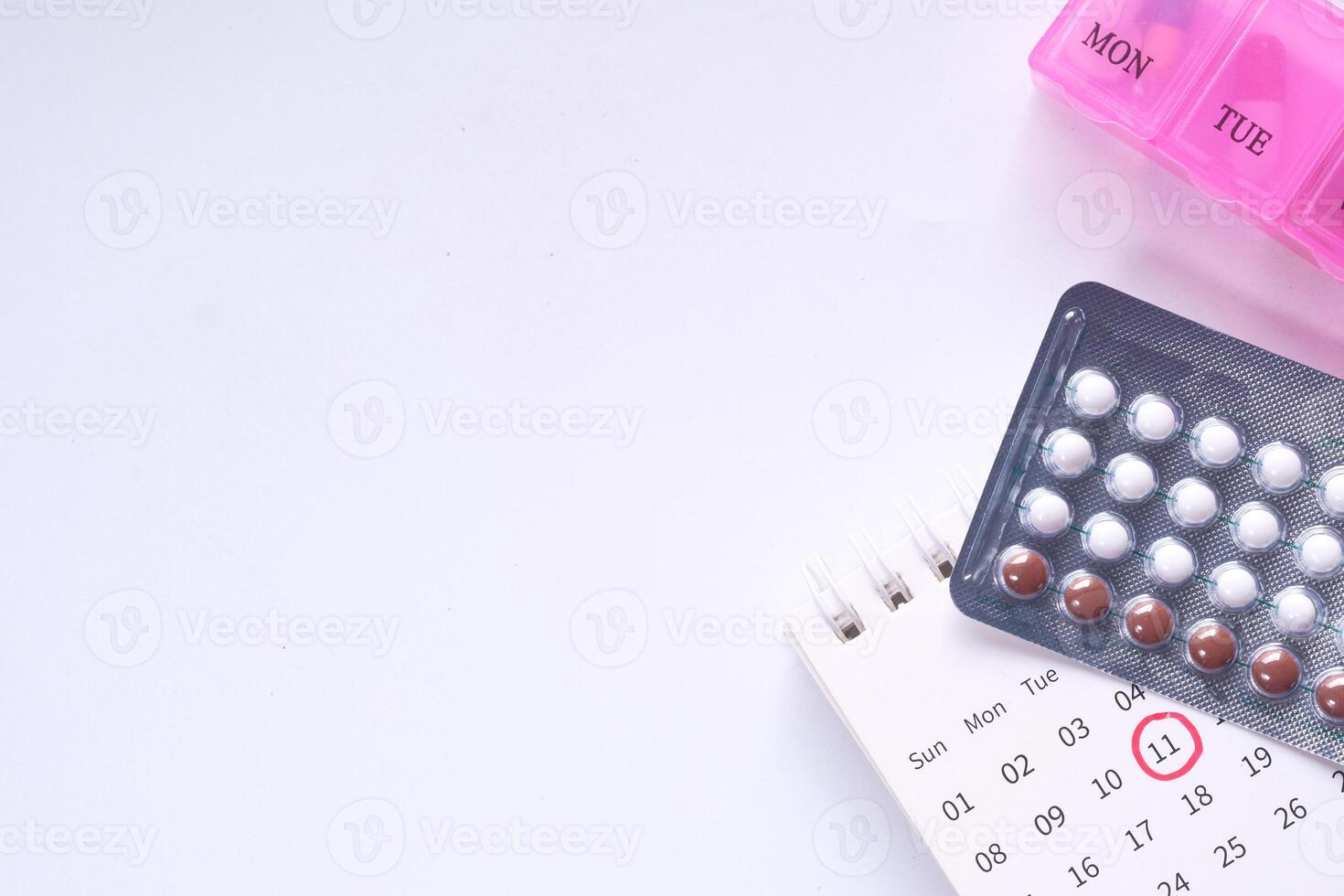 birth control pills on white background, close up photo