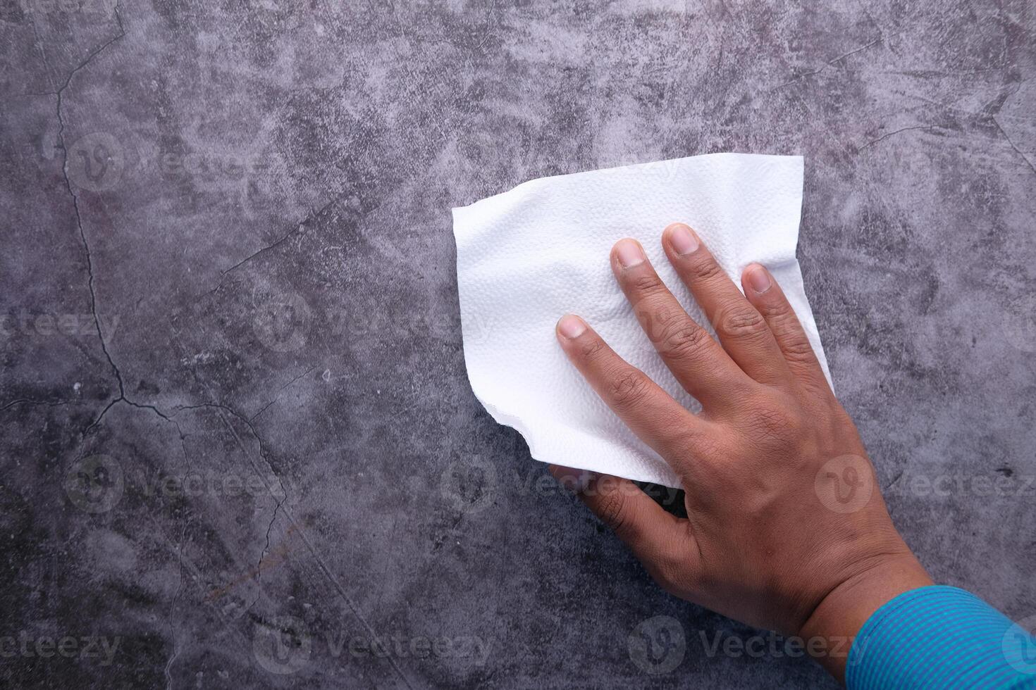 man hand with wet antibacterial wipe cleaning table photo