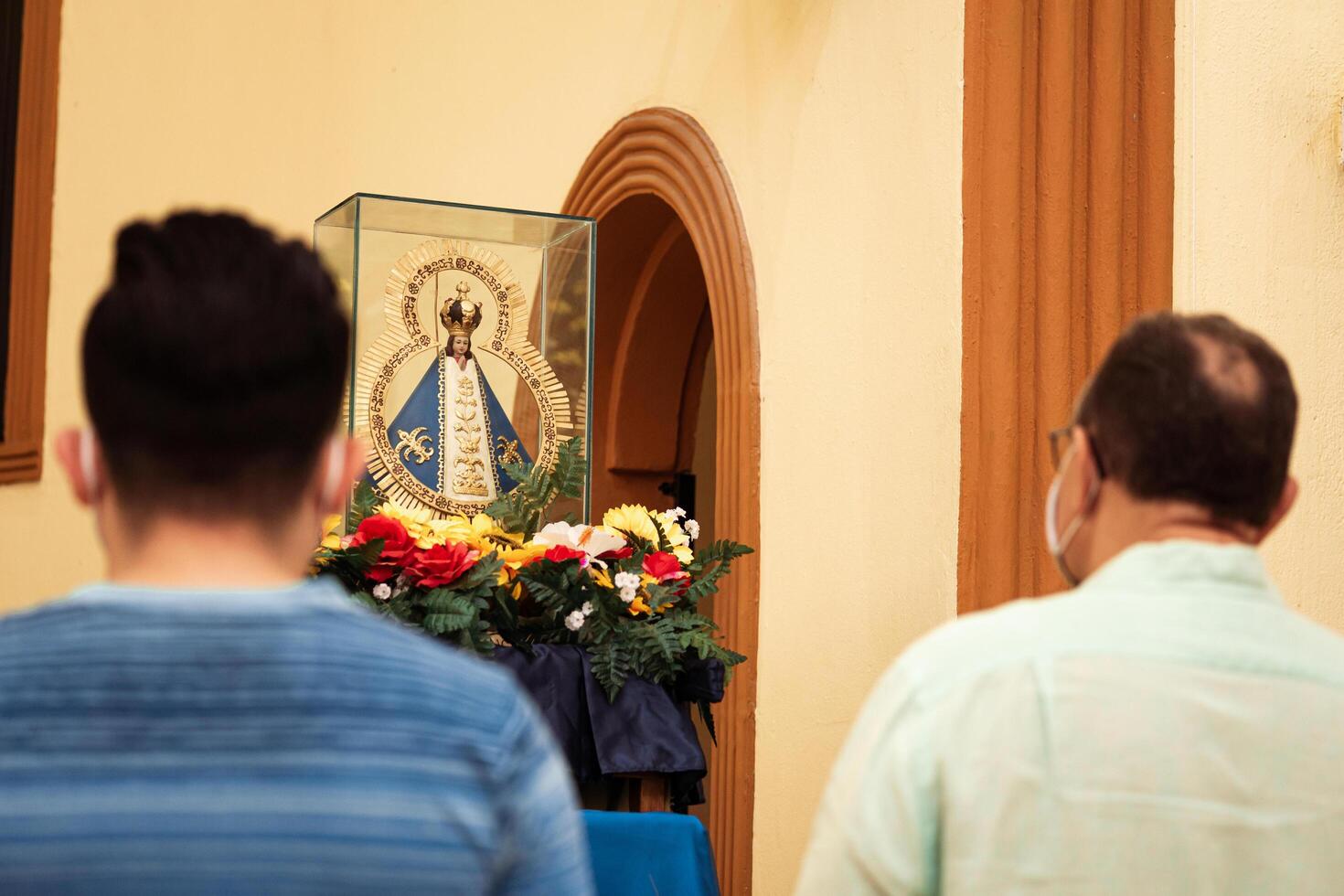 Unknown people praying front of the statue of Our Lady of Suyapa in the San Isidro Cathedral in La Ceiba, Honduras. photo