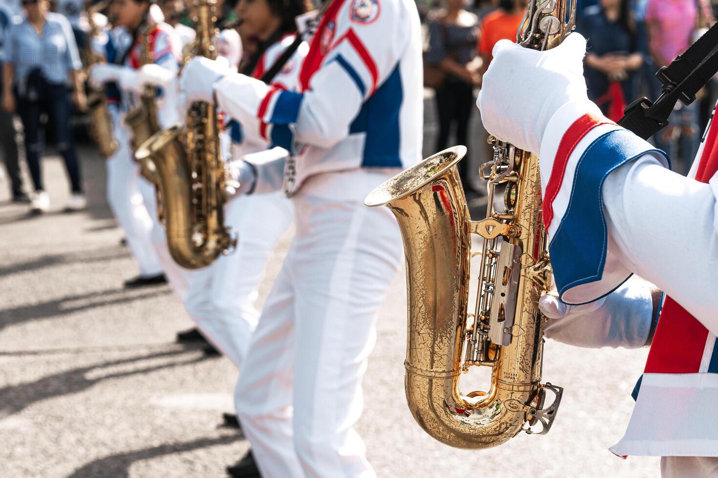 Group of saxophonists playing a saxophone in a patriotic march photo
