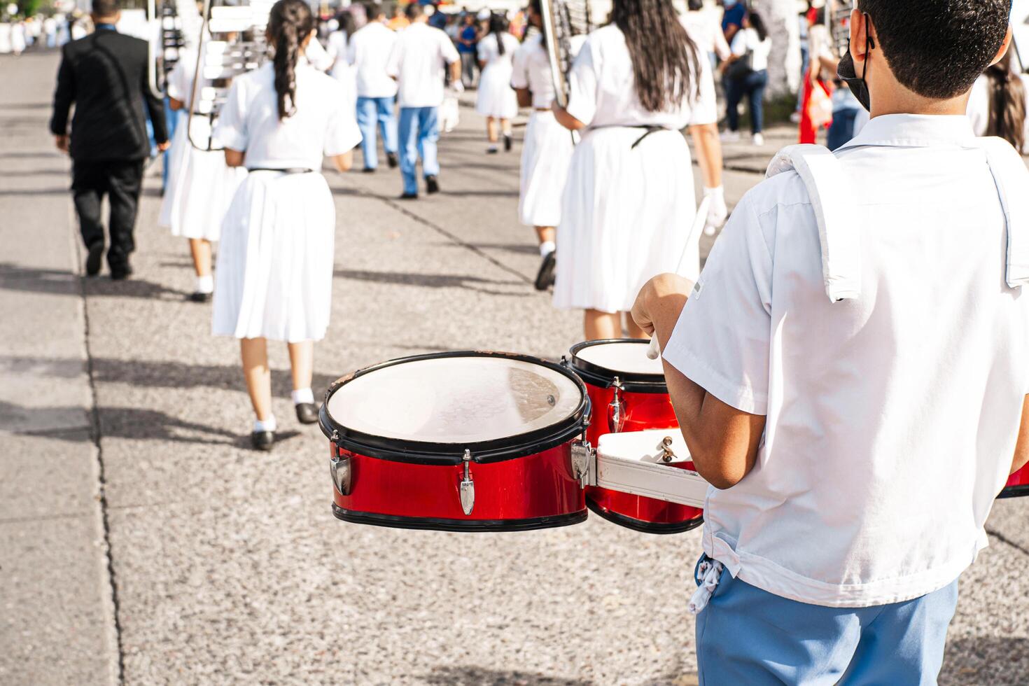 Hands of a percussionist playing an instrument in a parade. photo