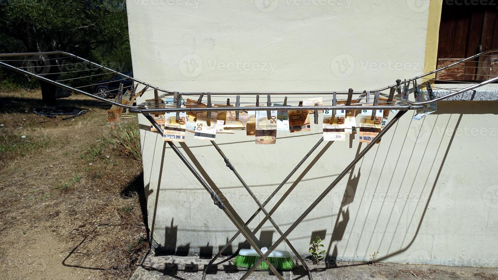 50 and 20 euro banknotes hung out to dry on a drying rack photo