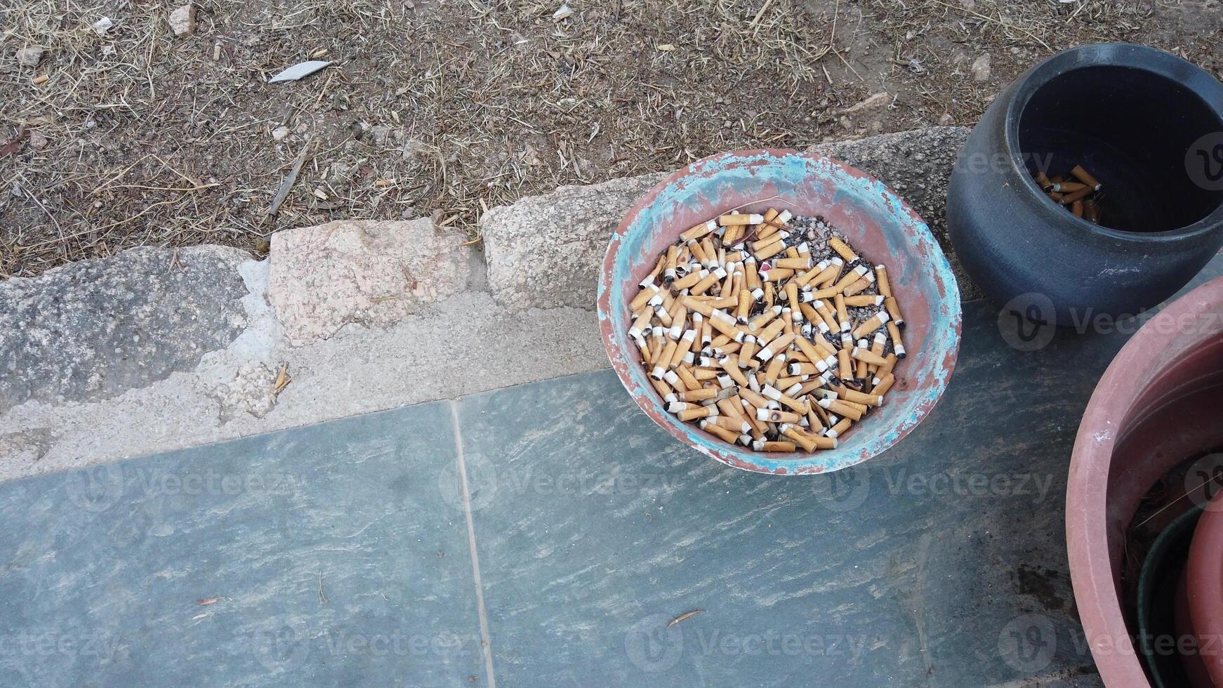 of a jar full of cigarette butts photo