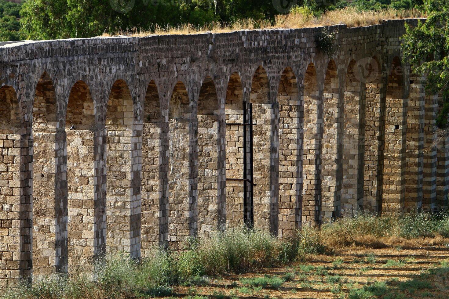 An ancient aqueduct for supplying water to populated areas. photo