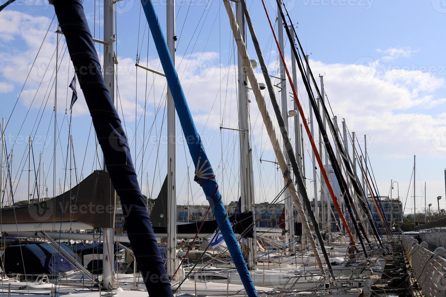 Masts in the port against the blue sky. photo