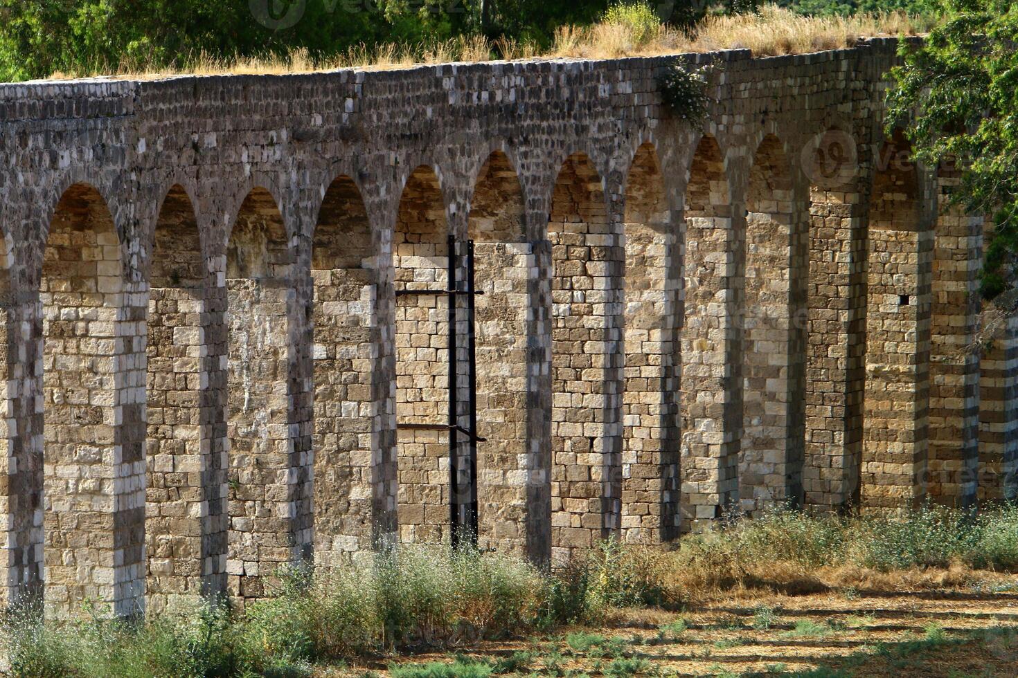An ancient aqueduct for supplying water to populated areas. photo