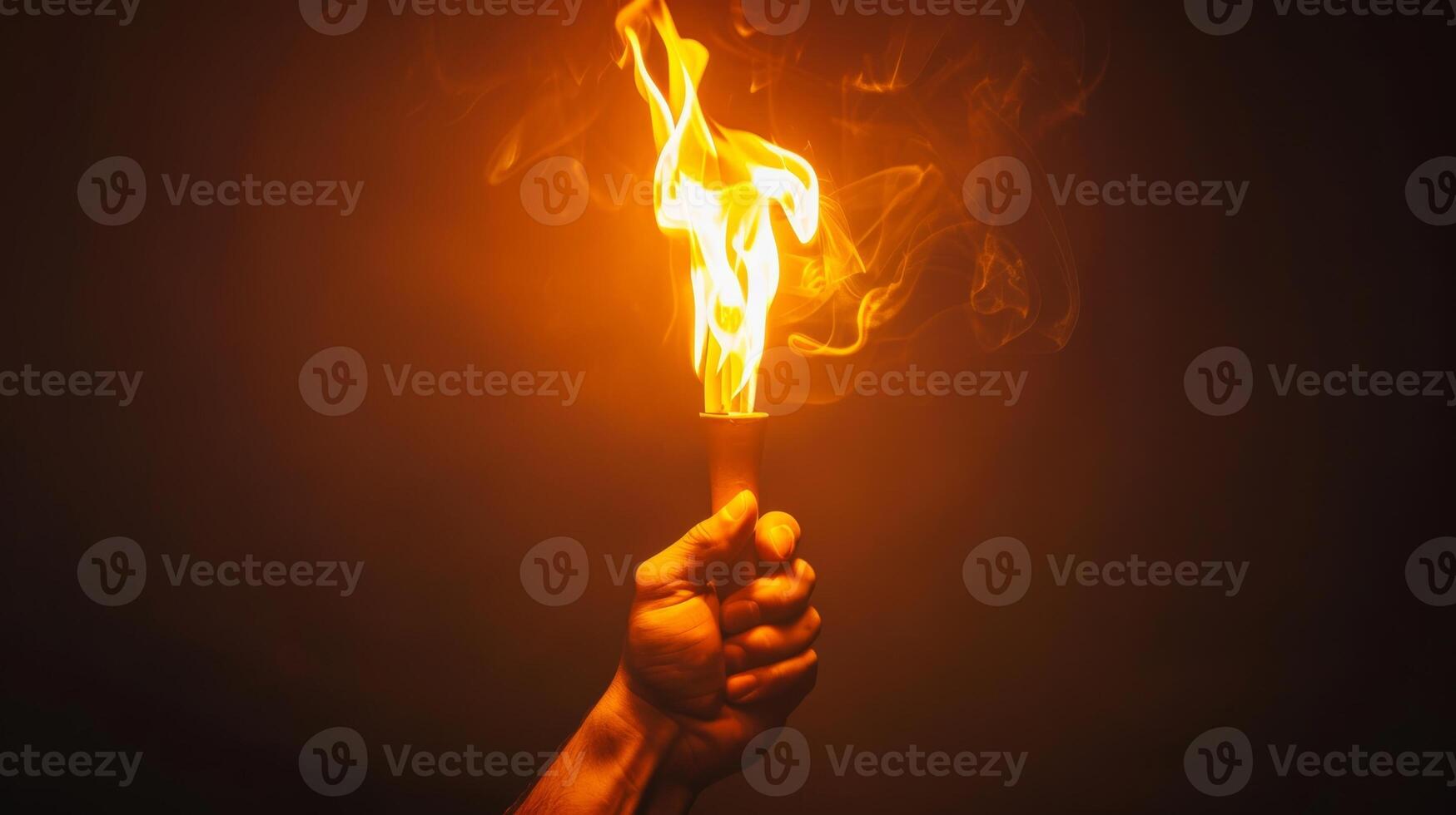 Hand Holding Flaming Torch with Smoke on Dark Background photo