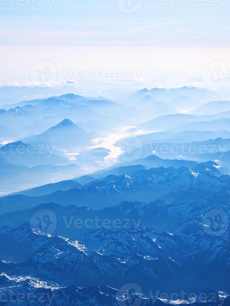 Aerial view of Alps, mountain range, stunning landscape scenery, travel and adventure background, flying over Alpsv photo