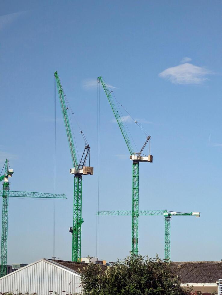 Big cranes at construction site in Dublin, Ireland, building and construction machines background photo