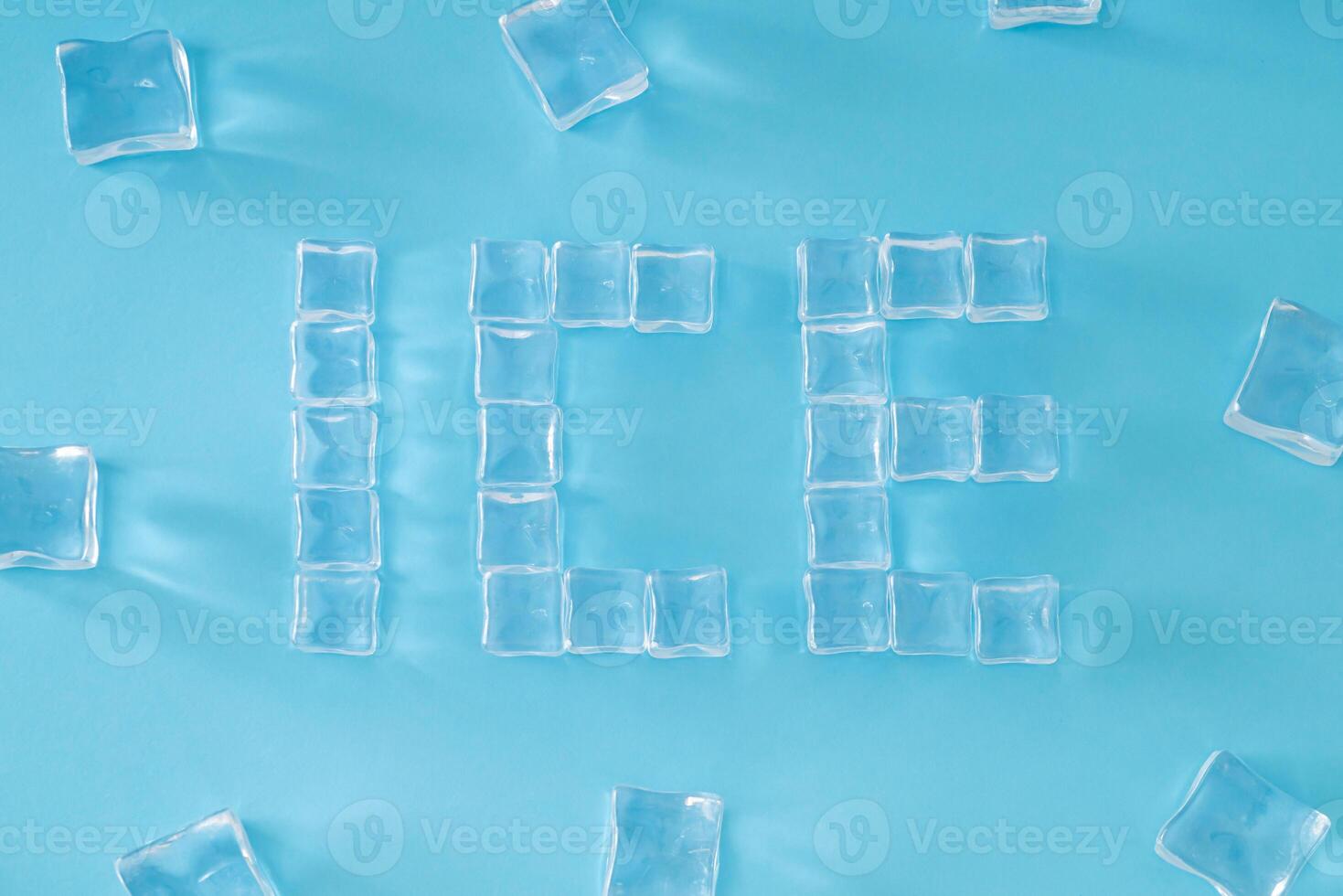 Word ICE made of ice cubes on light blue background. Minimal summer drink concept. Creative summertime composition. Flat lay, top of view. photo