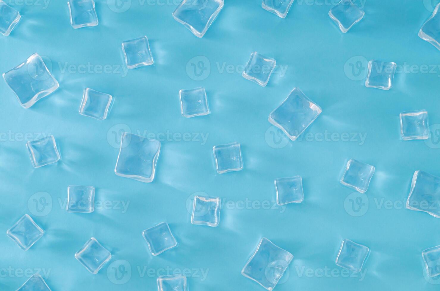 Ice cubes pattern on light blue background. Minimal summer drink concept. Trendy summertime pattern backdrop. Flat lay, top of view. photo