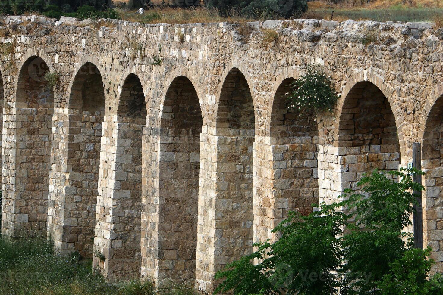 An ancient aqueduct for supplying water to populated areas. photo