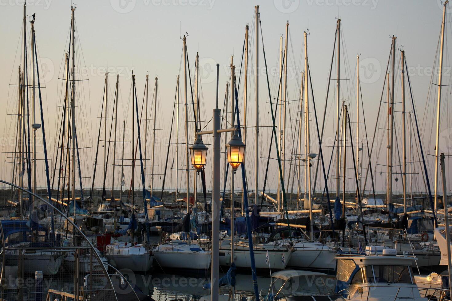 Masts in the port against the blue sky. photo