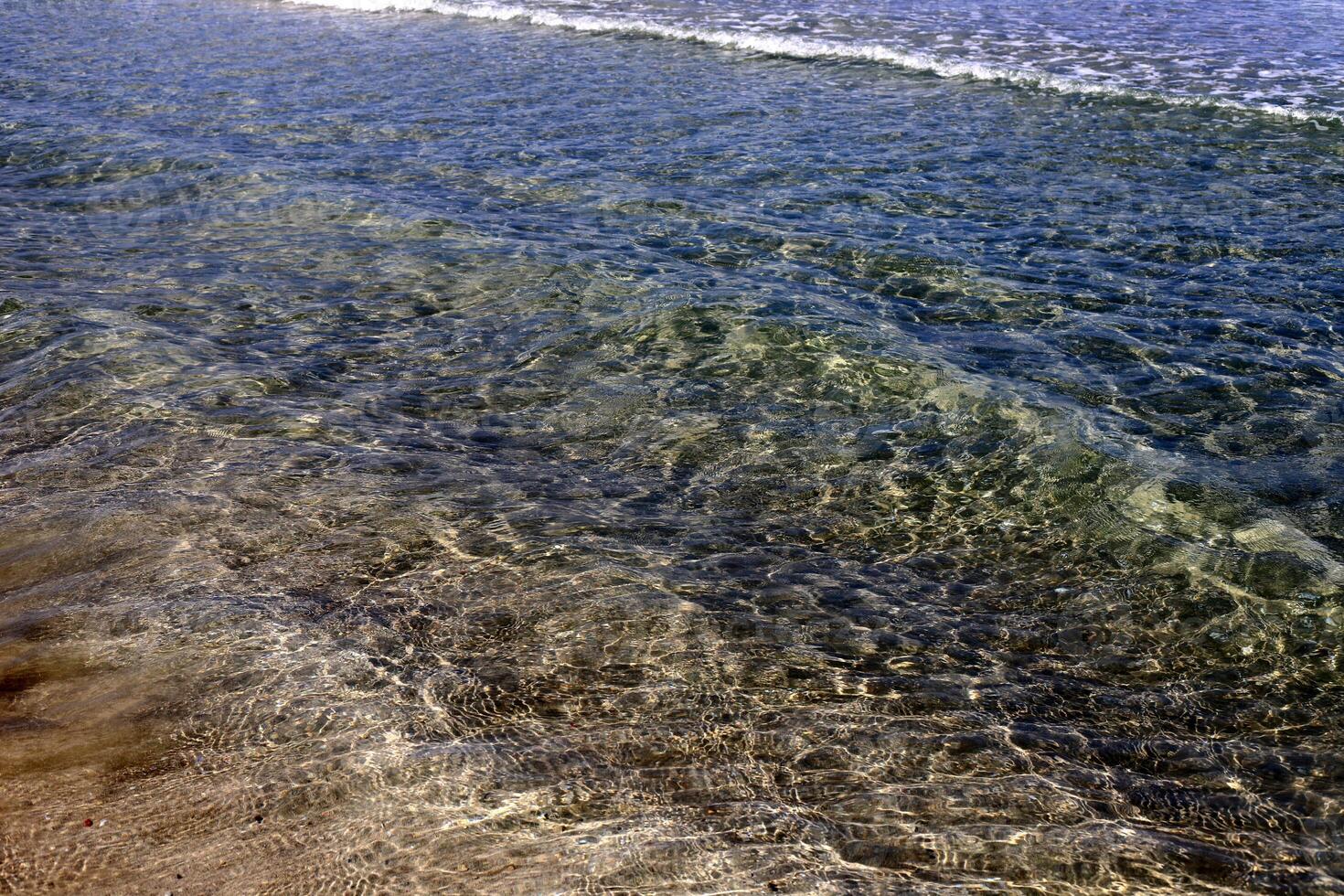 The color of water in the Mediterranean Sea in shallow water. Natural abstract background. photo
