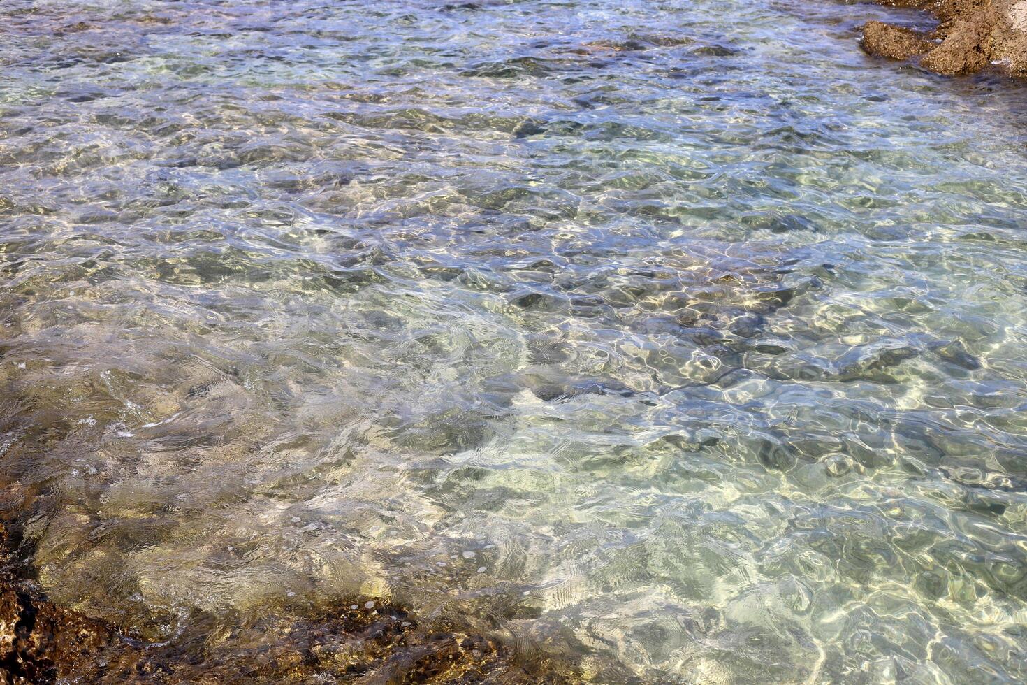 The color of water in the Mediterranean Sea in shallow water. Natural abstract background. photo