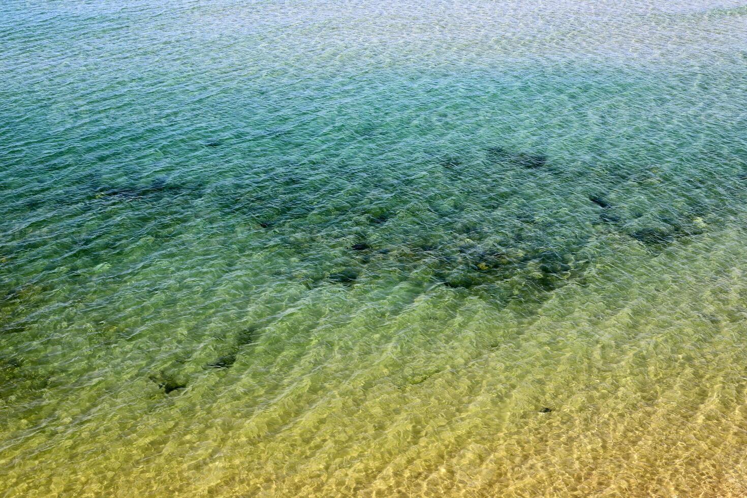 The color of water in the Mediterranean Sea in shallow water. Natural abstract background. photo