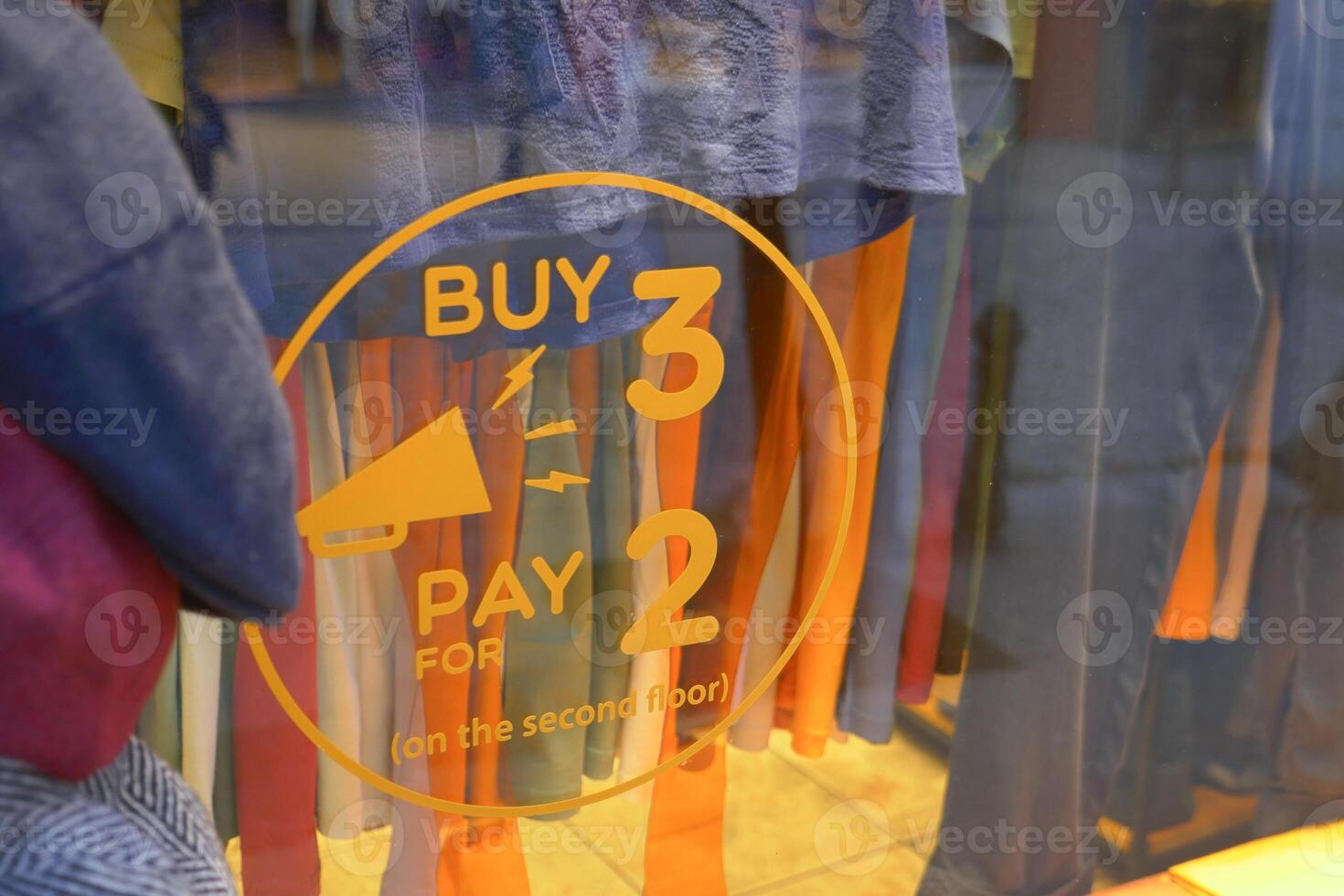 Large Sale text letters on red background on clothing store . photo