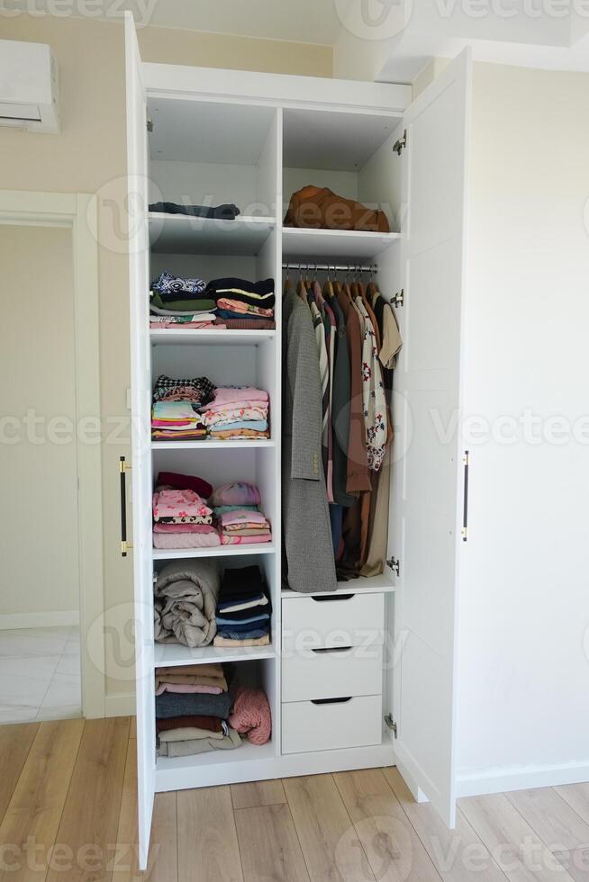 organizing clothes in a closet on shelves for comfort and ease of access photo