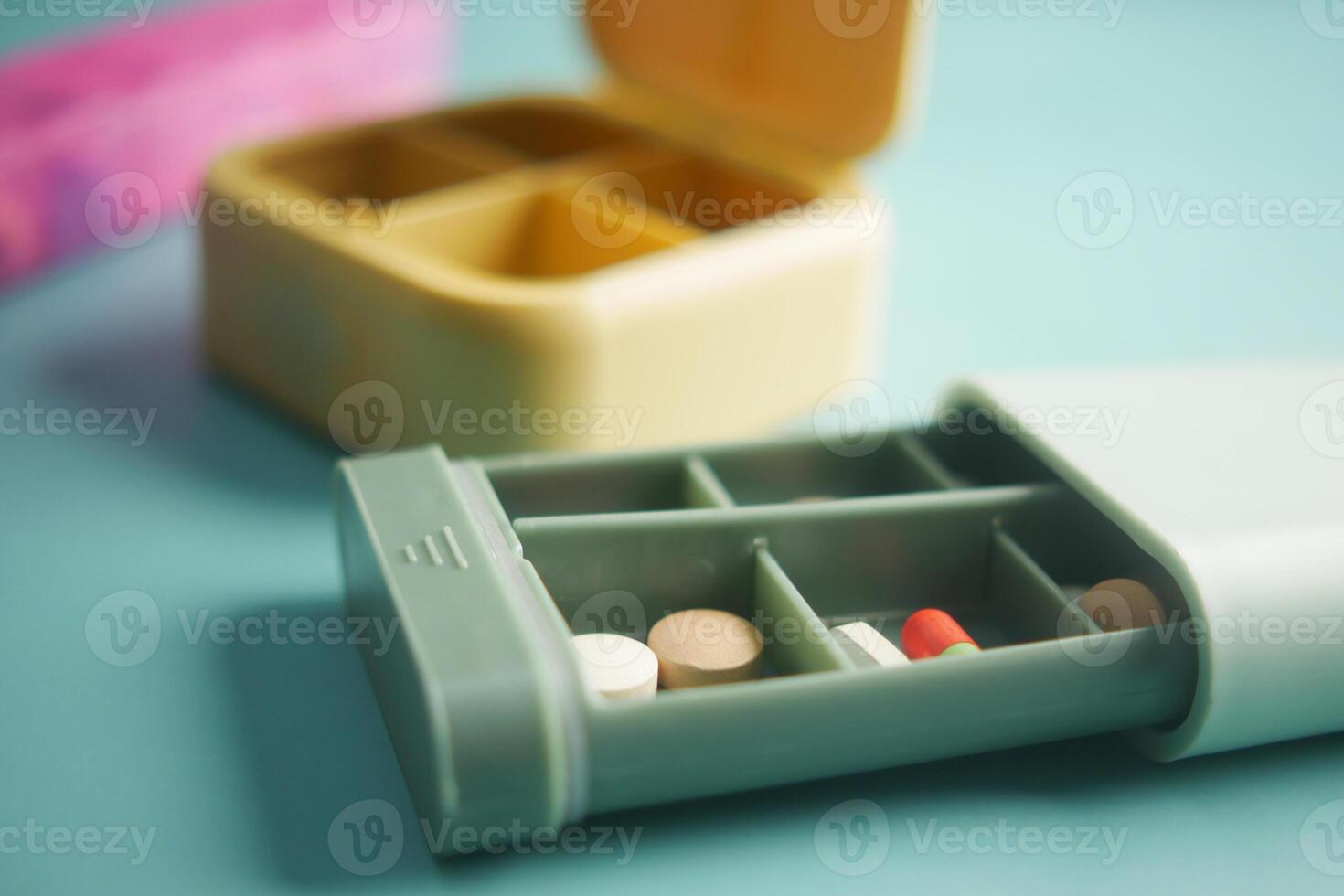 close up of medical pills in a pill box on table photo