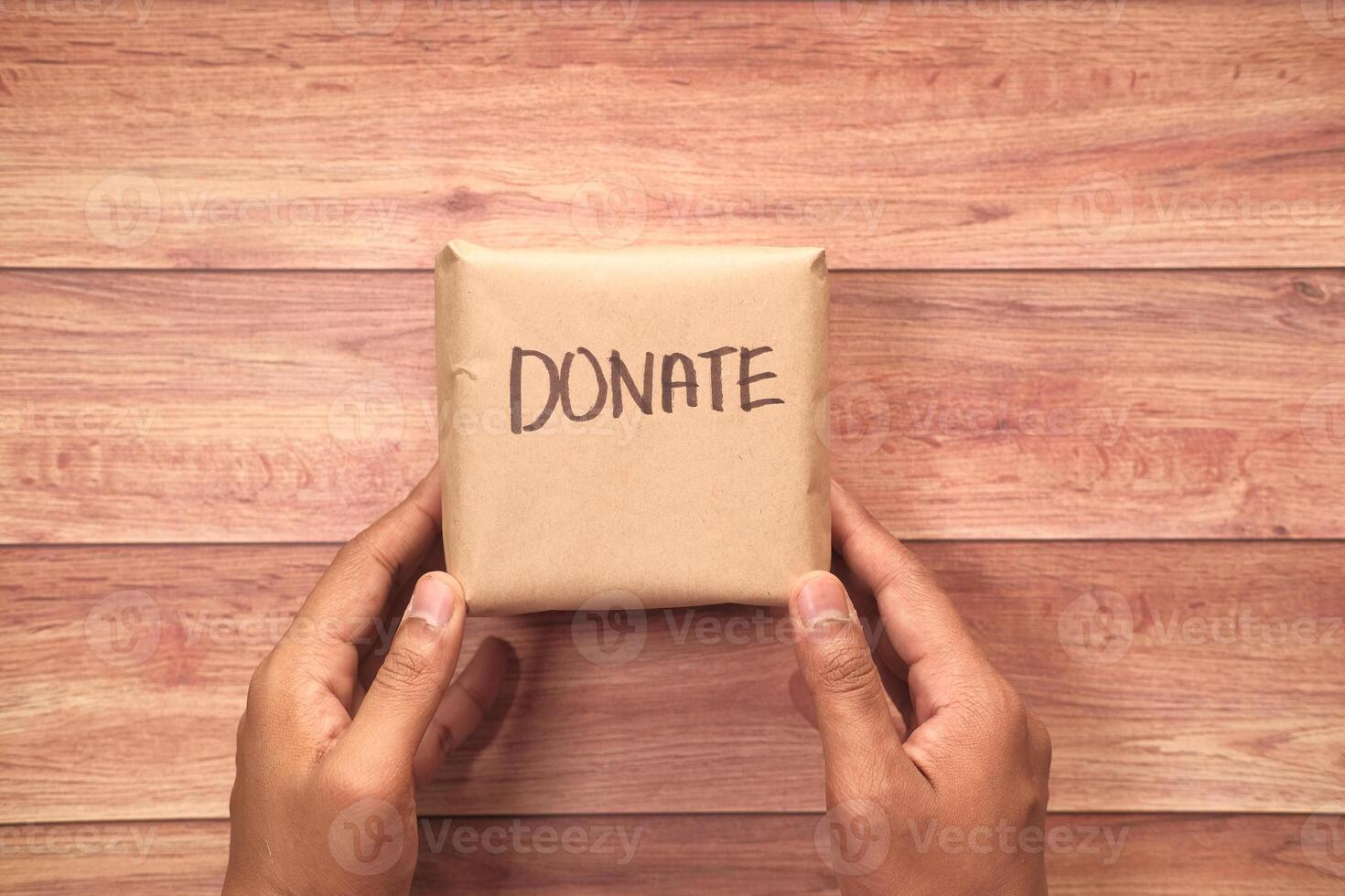 man hand holding donation box, top view photo