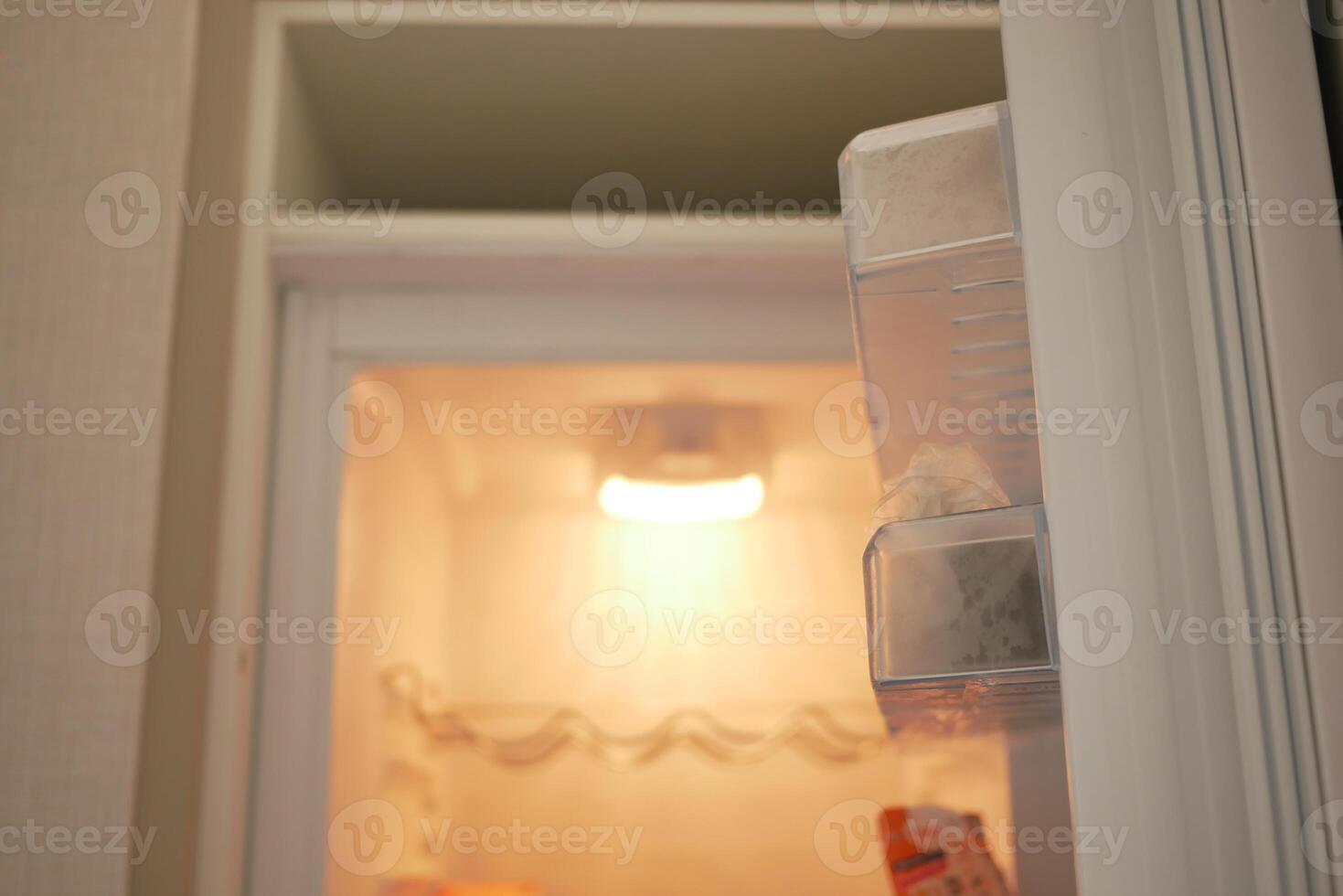 half open fridge with food and vegetables , photo