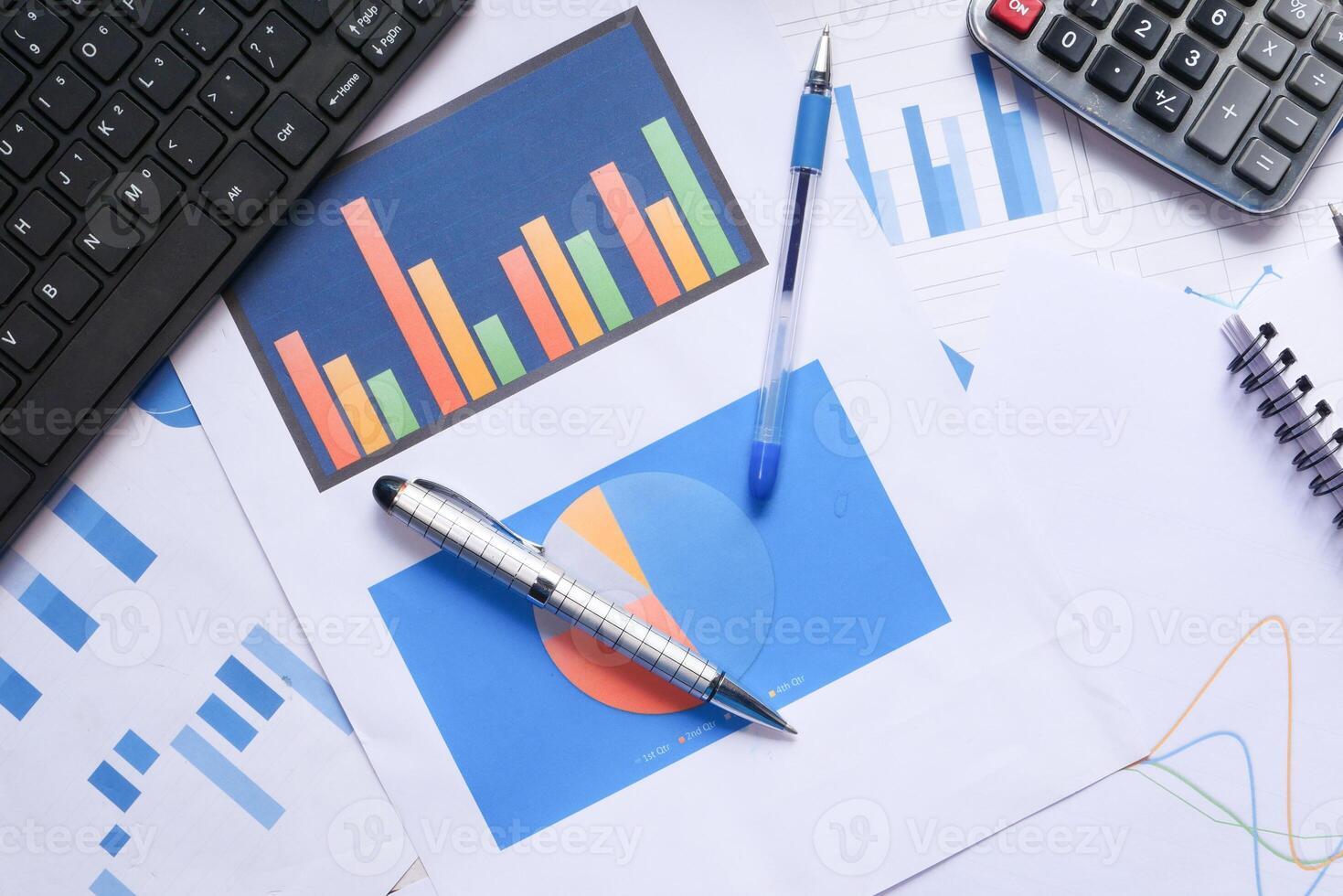 top view of financial charts and office stationary on table photo
