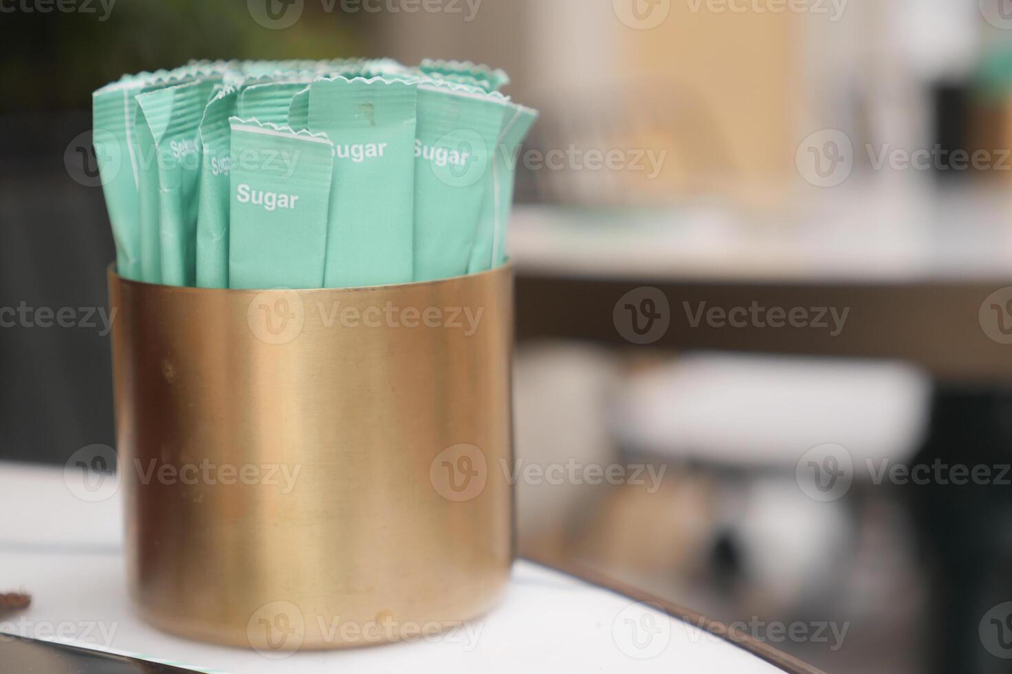 white sugar in a paper packet on table photo