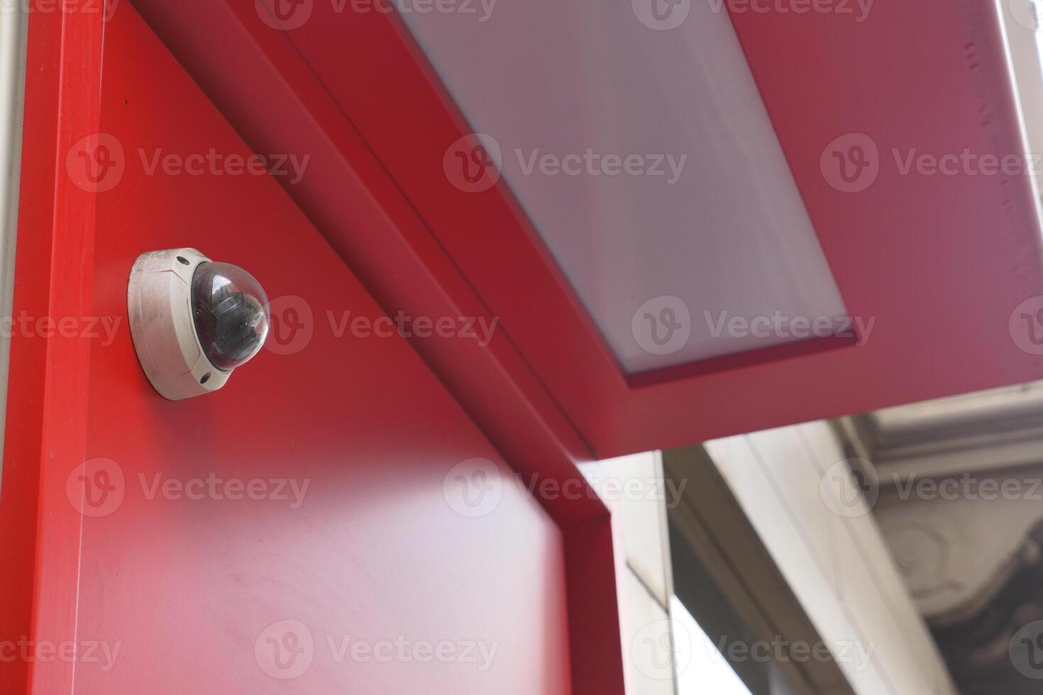 CCTV security camera operating on atm booth photo
