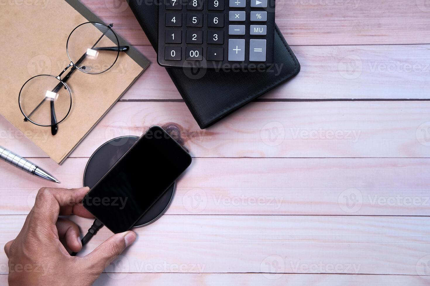 charging Smartphone Using Wireless Charging Pad, top view photo