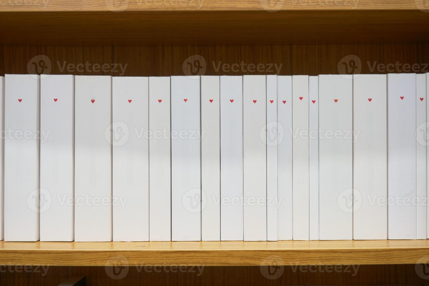 A lot of books are on the shelf in a public library or bookstore photo