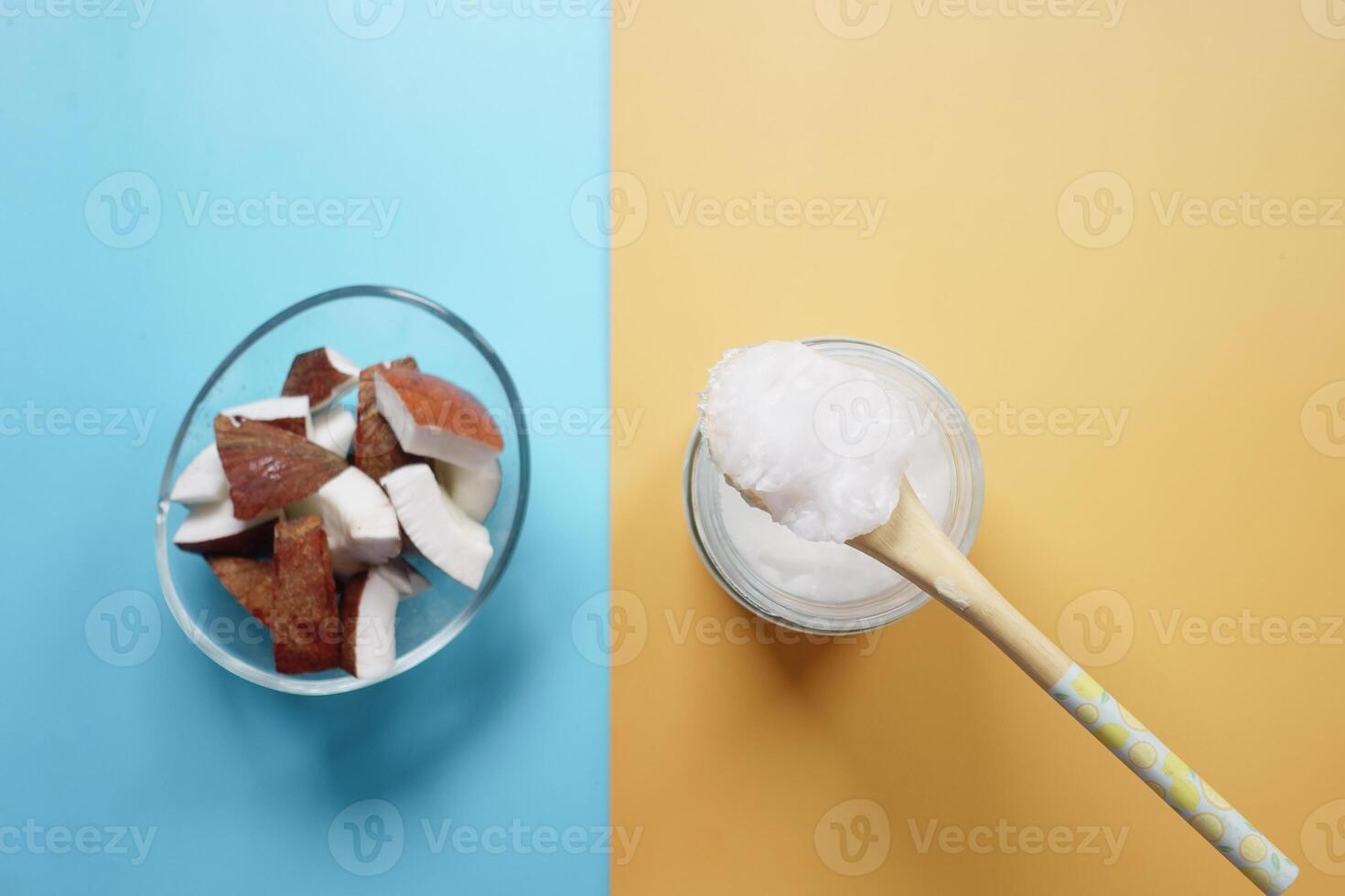 slice of fresh coconut and bottle of oil on a table photo