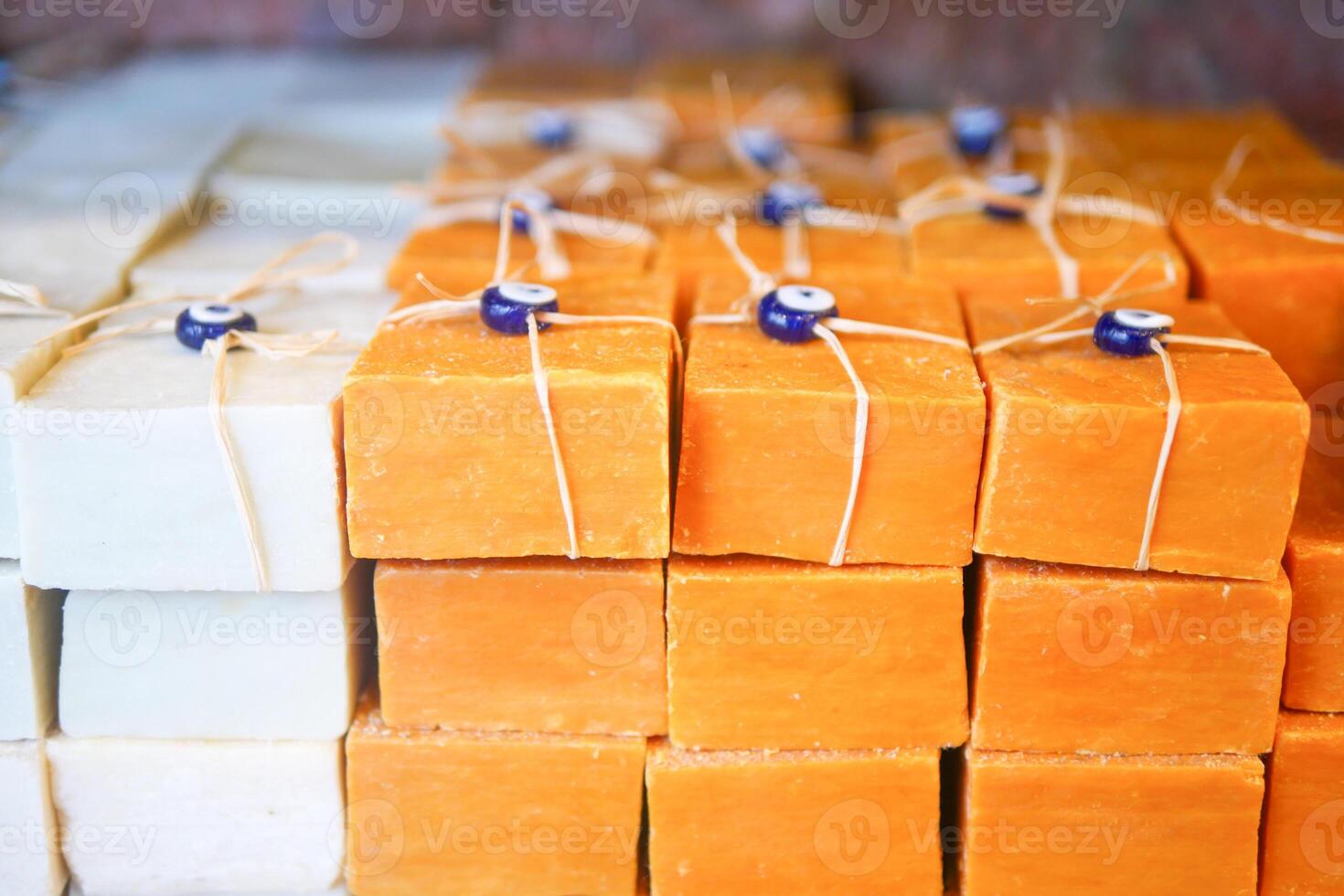 Stack of soap topped with evil eye beads, photo