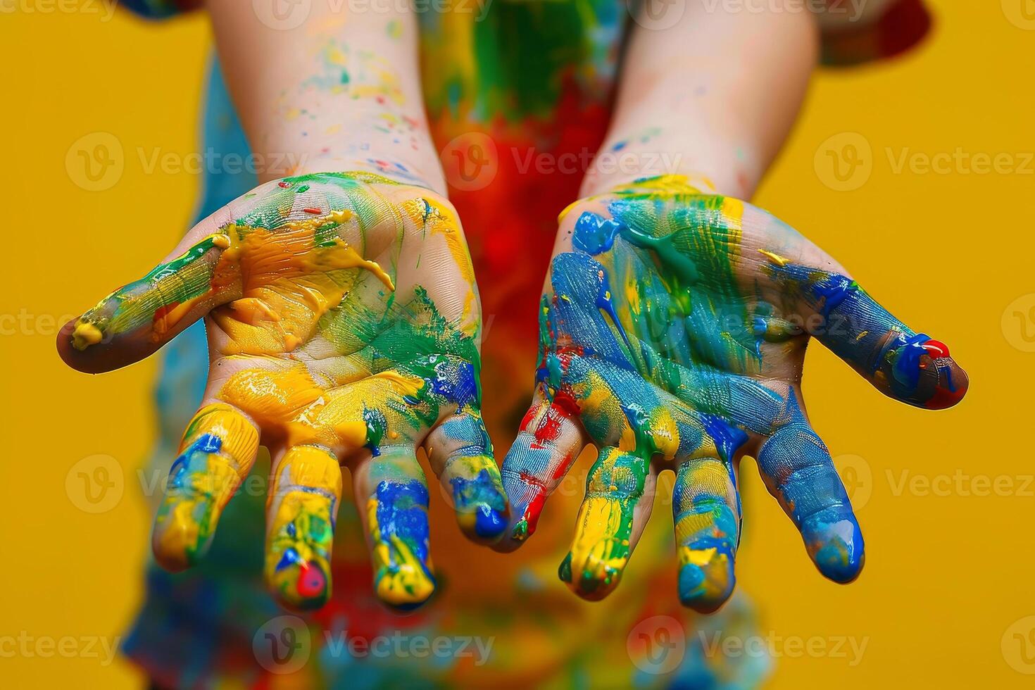 The hands are covered in paint and are being held up in the air photo
