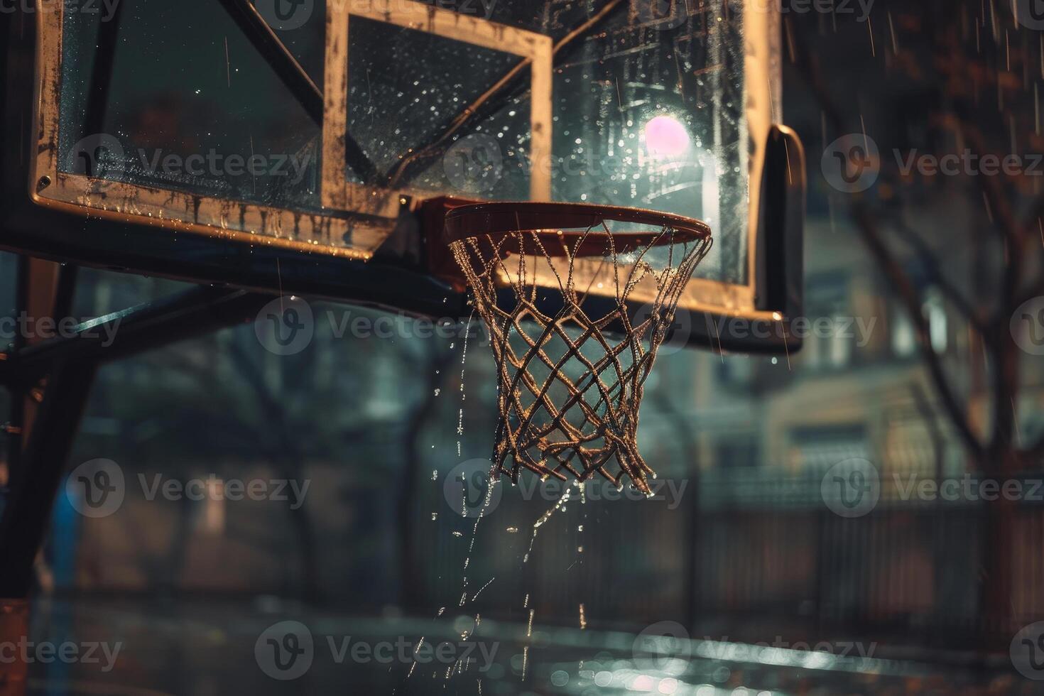 A basketball net is wet and the ball is missing photo