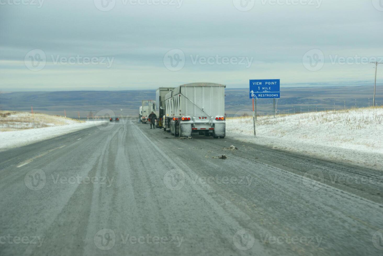 Trucks stop to remove chains photo