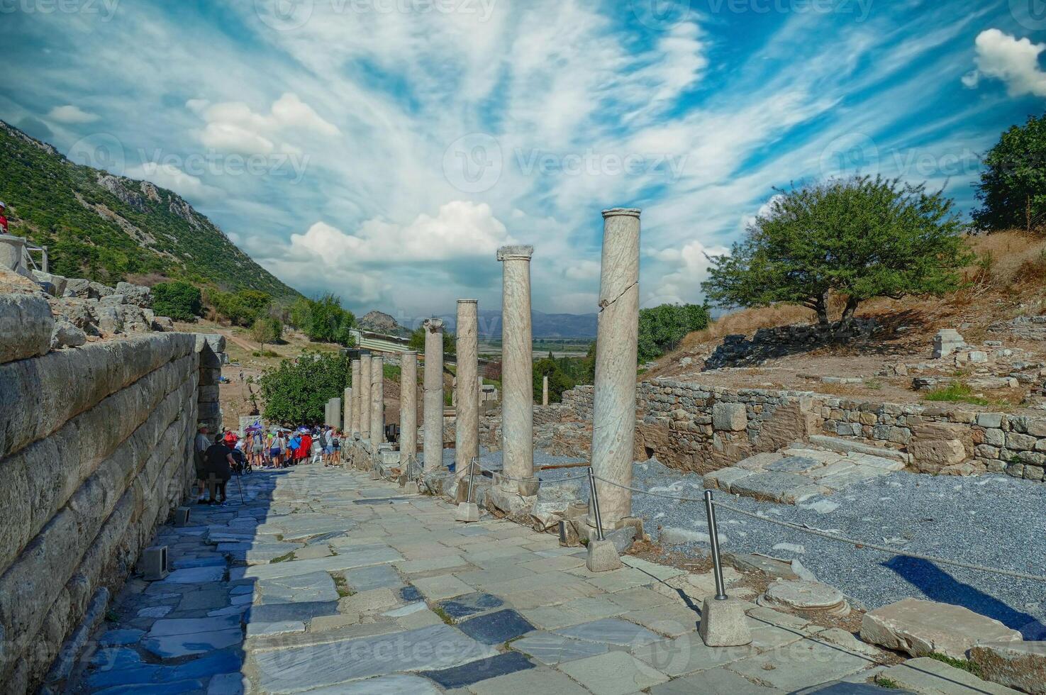Tourists walk down the Street of Curetes towards the Library of Celsus photo